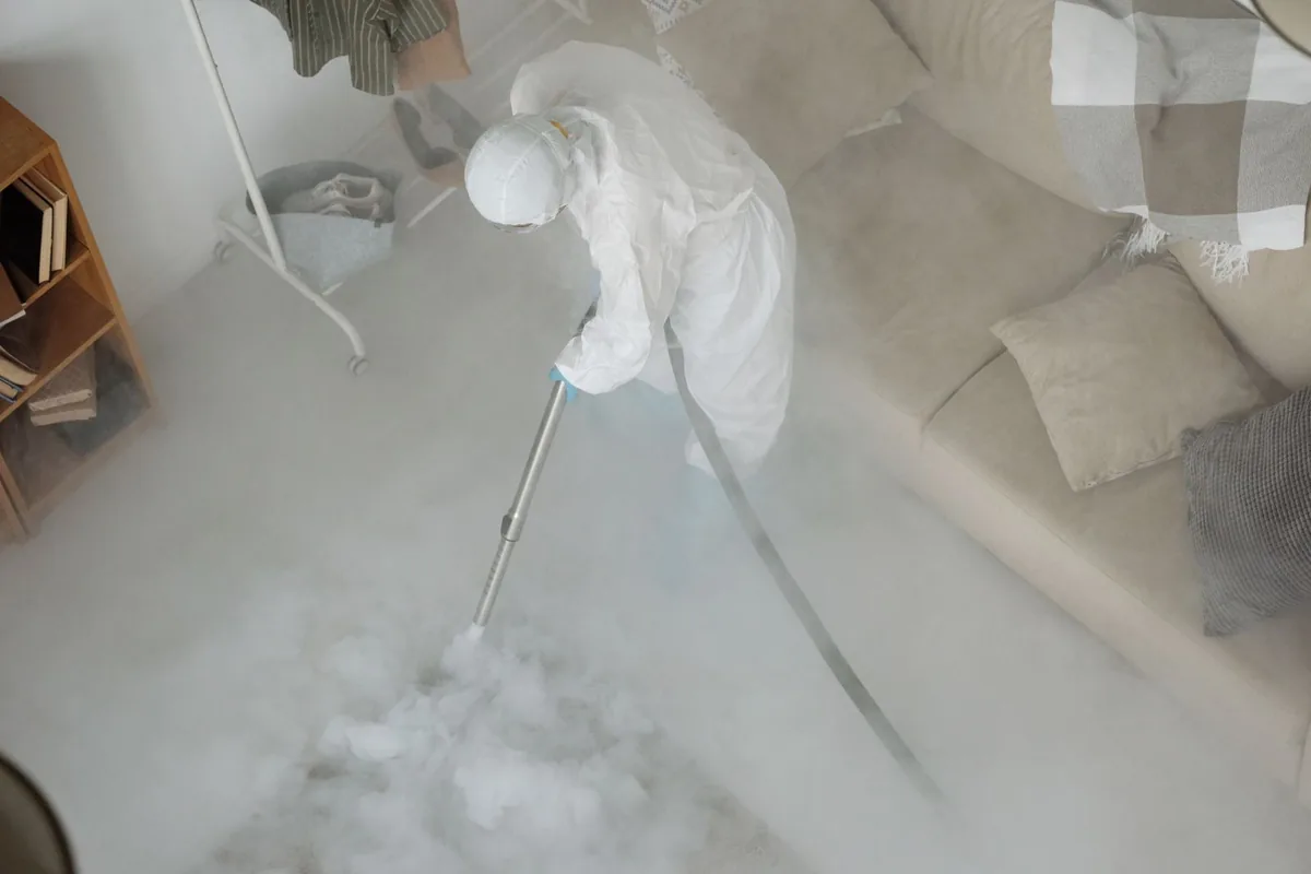 Biohazard cleanup technician in protective equipment, Deerwood, TX